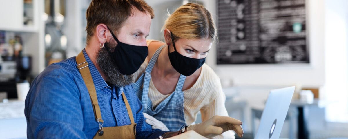 Coffee shop owners with face masks, lockdown, quarantine, coronavirus, back to normal concept.