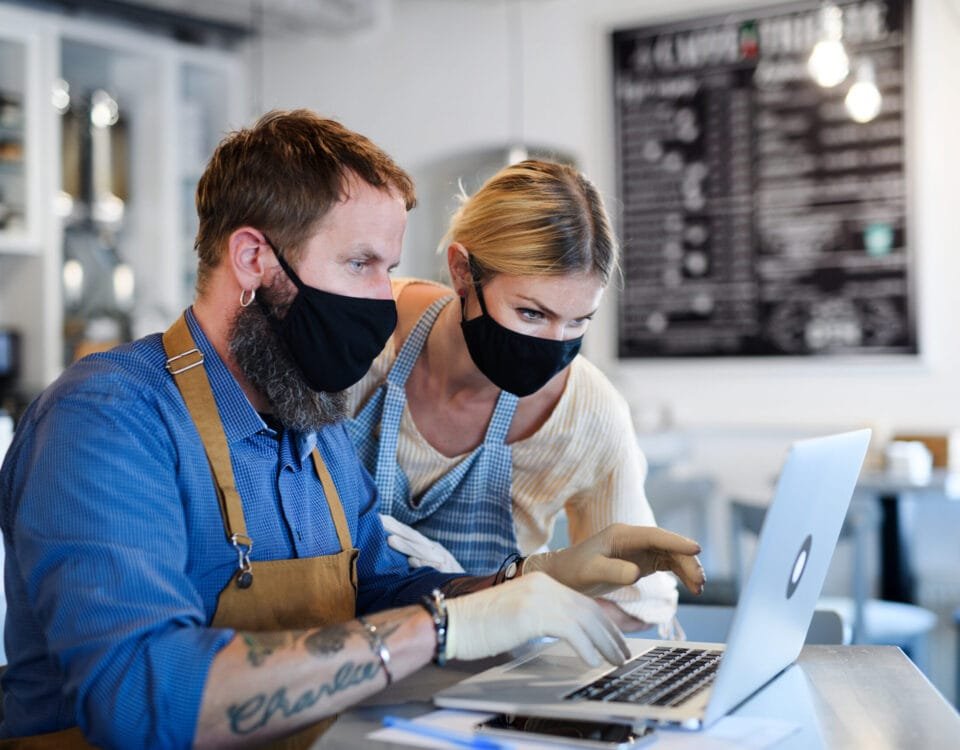 Coffee shop owners with face masks, lockdown, quarantine, coronavirus, back to normal concept.